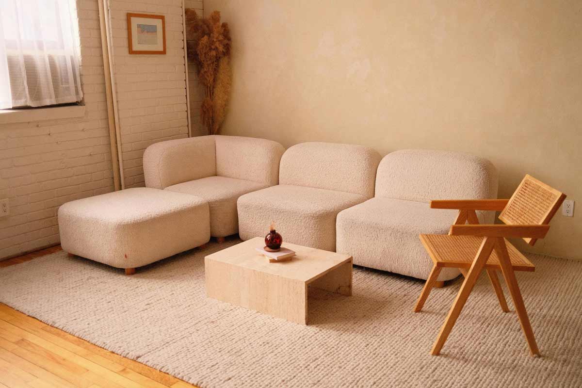 A Soft, Light Colored Sofa and a Wooden Chair in a Modern Living Room