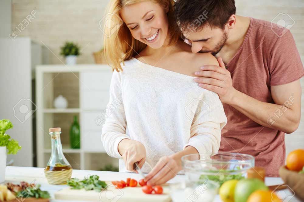 romantic-couple-cooking-salad-in-the-kitchen