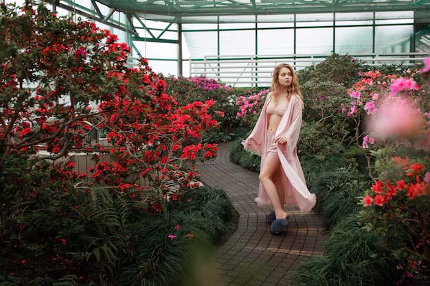 beautiful-sexy-girl-wearing-pink-bathrobe-lingerie-standing-flower-garden_8353-8398