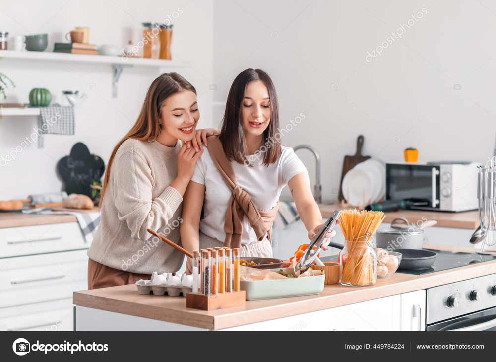 lesbian lovers working in kitchen