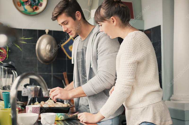 Young couple cooking in kitchen