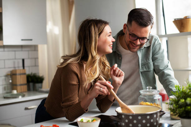 Boyfriend and girlfriend cooking together. Husband and wife making delicious food