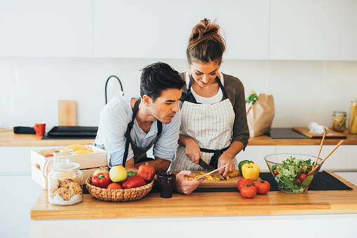 Young couple cooking in the kitchen.